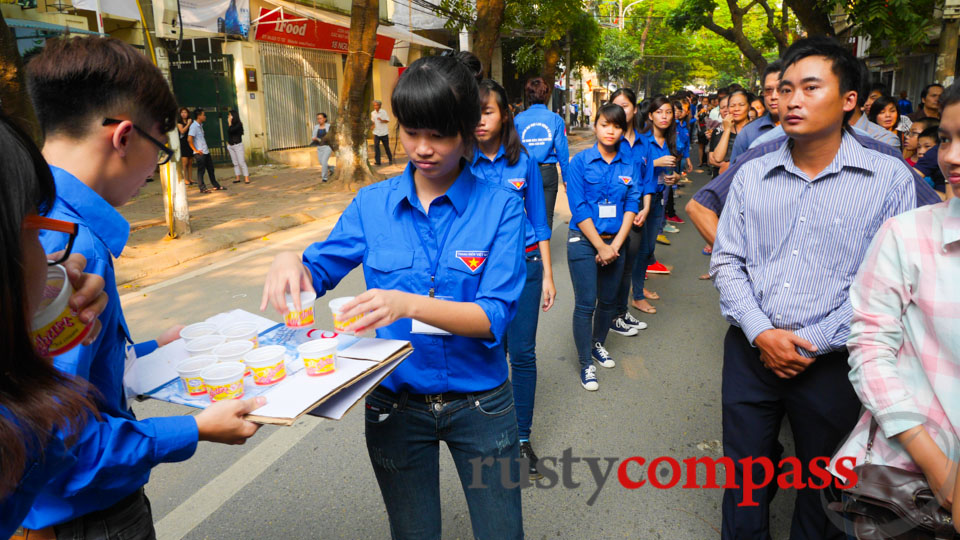 Communist Youth or Thanh Nien, mostly women, distribute water.